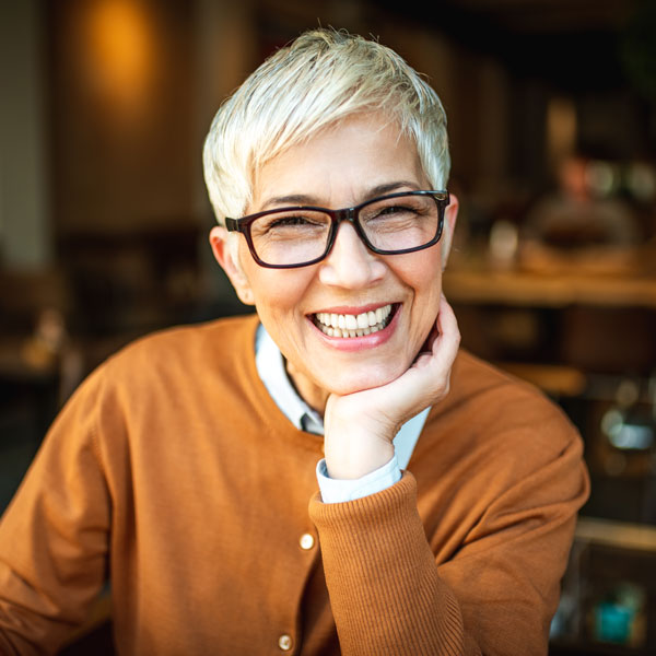 Woman smiling after emergency dental care in Wyoming, MI