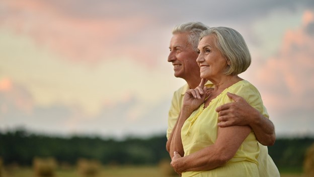 Couple smiling after undergoing enamel shaping procedure in Wyoming, MI