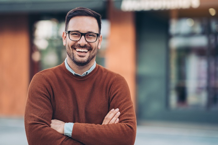 Man smiling after getting dental crowns in Wyoming, MI