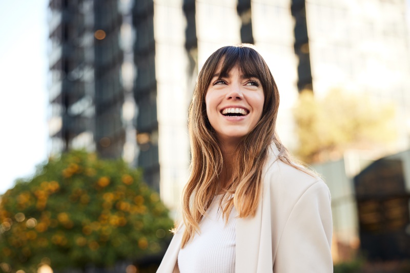 Woman after getting dental sealants to lower the risk of plaque build-up in Wyoming, MI